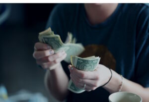 Woman counting cash bills