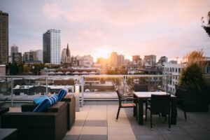 View of sunset from well-furnished rooftop patio