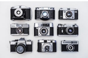 Assortment of nine photo cameras, three down and across
