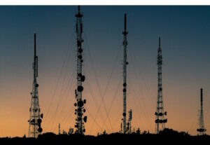 Telecommunication towers seen in the distance at dusk