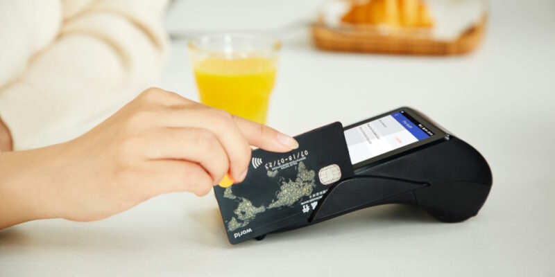 Woman swiping credit card in card reader